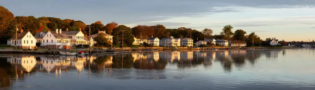 Panoramic view of residential homes during a vibrant sunrise. Taken in Mystic, Stonington, Connecticut, United States.